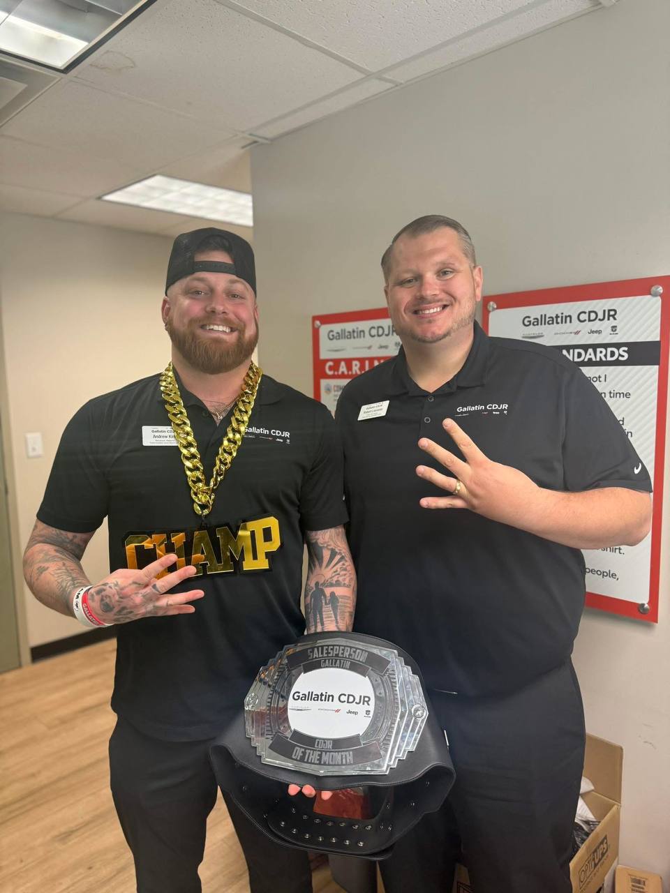Andrew Kirk holding the Gallatin CDJR Salesperson of the Month championship belt